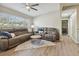 Inviting living room with recliners, modern fan, and view to another room at 3907 Elkcam Se Blvd, St Petersburg, FL 33705