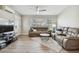 Comfortable living room with plush sofas, a modern rug, and light wood-look flooring at 3907 Elkcam Se Blvd, St Petersburg, FL 33705