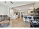 Open-concept living room with seating and view to bar seating and bright kitchen at 3907 Elkcam Se Blvd, St Petersburg, FL 33705