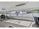 Spacious screened patio with a grill, table and chairs, perfect for outdoor entertaining and dining at 3907 Elkcam Se Blvd, St Petersburg, FL 33705