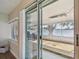 View of a spacious screened patio with wood flooring, accessed through sliding glass doors, offering a relaxing outdoor space at 3907 Elkcam Se Blvd, St Petersburg, FL 33705