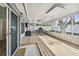 Expansive screened patio with wood flooring, fans, lighting, and furniture for outdoor enjoyment at 3907 Elkcam Se Blvd, St Petersburg, FL 33705