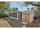 The backyard features a screened in porch attached to the house and a matching storage shed at 3915 N Ola Ave, Tampa, FL 33603