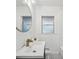 Bathroom features a round mirror, patterned floor tiles, and modern vanity at 3915 N Ola Ave, Tampa, FL 33603