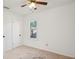 This bedroom includes a ceiling fan, white walls, carpet, and a window at 3915 N Ola Ave, Tampa, FL 33603