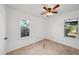 Clean bedroom with carpet, ceiling fan, and windows that provide good light at 3915 N Ola Ave, Tampa, FL 33603