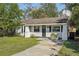 Charming one-story home with a well-maintained lawn and a neatly landscaped front yard at 3915 N Ola Ave, Tampa, FL 33603