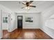 Bright living room with hardwood floors, a ceiling fan, and a large window offering natural light at 3915 N Ola Ave, Tampa, FL 33603