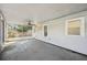 Covered outdoor porch, featuring a ceiling fan, white siding and a window at 3915 N Ola Ave, Tampa, FL 33603