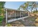 A rear view of the property featuring a screened in porch and a small storage shed at 3915 N Ola Ave, Tampa, FL 33603