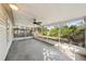 Spacious screened porch offering an airy outdoor living space and featuring a ceiling fan at 3915 N Ola Ave, Tampa, FL 33603