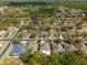 An aerial view of a neighborhood with well-maintained lawns and mature trees at 4421 Larkenheath Dr, Spring Hill, FL 34609