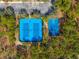 Aerial view of tennis and basketball courts surrounded by lush greenery at 4421 Larkenheath Dr, Spring Hill, FL 34609