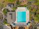 Aerial view of a lap swimming pool surrounded by lounge chairs, tables, and cabanas at 4421 Larkenheath Dr, Spring Hill, FL 34609