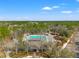 Aerial view of a community pool, recreation center, and playground area at 4421 Larkenheath Dr, Spring Hill, FL 34609
