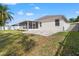 Spacious backyard with a screened-in patio and privacy fence at 4421 Larkenheath Dr, Spring Hill, FL 34609