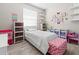 Bright bedroom featuring wood floors and playful decor elements at 4421 Larkenheath Dr, Spring Hill, FL 34609