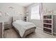 Charming bedroom with white walls, wood floors, and natural light from the window at 4421 Larkenheath Dr, Spring Hill, FL 34609