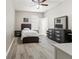 Cozy bedroom features light wood floors, ceiling fan, and neutral walls at 4421 Larkenheath Dr, Spring Hill, FL 34609