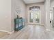 Bright foyer features wood-look tile flooring and decorative double-door entryway, creating an inviting ambiance at 4421 Larkenheath Dr, Spring Hill, FL 34609