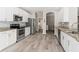Well-equipped kitchen features stainless steel appliances, granite countertops, and wood-look tile flooring at 4421 Larkenheath Dr, Spring Hill, FL 34609