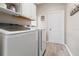 Functional laundry room with modern washer and dryer, and ample storage at 4421 Larkenheath Dr, Spring Hill, FL 34609