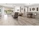 Inviting open-concept living space with modern tile flooring, ample seating, and a seamless flow to the outdoors at 4421 Larkenheath Dr, Spring Hill, FL 34609