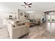 Open-concept living space with tile floors, comfortable seating, and views of the kitchen and dining area at 4421 Larkenheath Dr, Spring Hill, FL 34609
