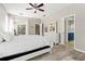 Bright main bedroom offering access to the lanai, with a glimpse of the en-suite bathroom at 4421 Larkenheath Dr, Spring Hill, FL 34609
