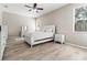 Tranquil main bedroom with abundant natural light and neutral decor with wood-look tile flooring at 4421 Larkenheath Dr, Spring Hill, FL 34609