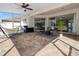 Large screened-in patio with brick flooring and outdoor furniture at 4421 Larkenheath Dr, Spring Hill, FL 34609