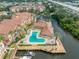 Aerial of community pool and recreation area overlooking serene waterway with boat docks at 5000 Culbreath Key Way # 9-102, Tampa, FL 33611