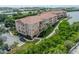 Aerial view of multi-story condo building with waterfront access and private parking at 5000 Culbreath Key Way # 9-102, Tampa, FL 33611