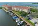 Aerial view of waterfront condos, boat docks, and lush green landscaping at 5000 Culbreath Key Way # 9-102, Tampa, FL 33611
