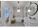 Charming bathroom with a freestanding tub, stylish fixtures, and patterned floor tiles at 5000 Culbreath Key Way # 9-102, Tampa, FL 33611