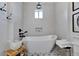 Serene bathroom with a freestanding tub, minimalist design, and tiled accents at 5000 Culbreath Key Way # 9-102, Tampa, FL 33611