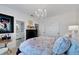 A calming bedroom showcases a private bathroom, hardwood floors and chandelier lighting at 5000 Culbreath Key Way # 9-102, Tampa, FL 33611