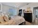 This lovely bedroom has a decorative chandelier, light walls, and direct access to a private bathroom at 5000 Culbreath Key Way # 9-102, Tampa, FL 33611