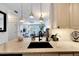 Modern kitchen featuring granite countertops, a black sink, white cabinets, and pendant lighting offering a sleek design at 5000 Culbreath Key Way # 9-102, Tampa, FL 33611