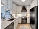 Modern kitchen featuring stainless steel appliances, white cabinets, and a black range hood offering a sleek design at 5000 Culbreath Key Way # 9-102, Tampa, FL 33611