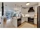 Open kitchen with white cabinets, stainless steel appliances, and a center island, seamlessly flowing into the living area at 5000 Culbreath Key Way # 9-102, Tampa, FL 33611