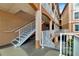 Exterior staircase with white railings leading to condo units, offering a stylish entrance at 5000 Culbreath Key Way # 9-102, Tampa, FL 33611