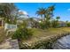Lush backyard featuring tropical plants, waterfront views, and a tranquil atmosphere at 5229 Brighton Shore Dr, Apollo Beach, FL 33572