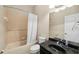 Bathroom featuring tiled shower, tub, toilet and vanity with dark countertop at 5229 Brighton Shore Dr, Apollo Beach, FL 33572