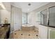 Bathroom featuring a tub, separate shower, and neutral tile floors, and a sleek vanity with dark countertops at 5229 Brighton Shore Dr, Apollo Beach, FL 33572