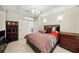 Comfortable bedroom featuring tiled floors, French doors, and neutral color scheme at 5229 Brighton Shore Dr, Apollo Beach, FL 33572