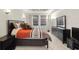Comfortable bedroom with large windows, tiled flooring, and dark wood furniture at 5229 Brighton Shore Dr, Apollo Beach, FL 33572