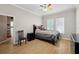 Bedroom with natural light, laminate flooring, a ceiling fan, and neutral walls, providing a peaceful retreat at 5229 Brighton Shore Dr, Apollo Beach, FL 33572