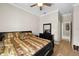 Bedroom featuring a ceiling fan, wood floors, and view into hallway at 5229 Brighton Shore Dr, Apollo Beach, FL 33572