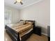 Bedroom featuring a ceiling fan, wood floors, and shutters on the window at 5229 Brighton Shore Dr, Apollo Beach, FL 33572